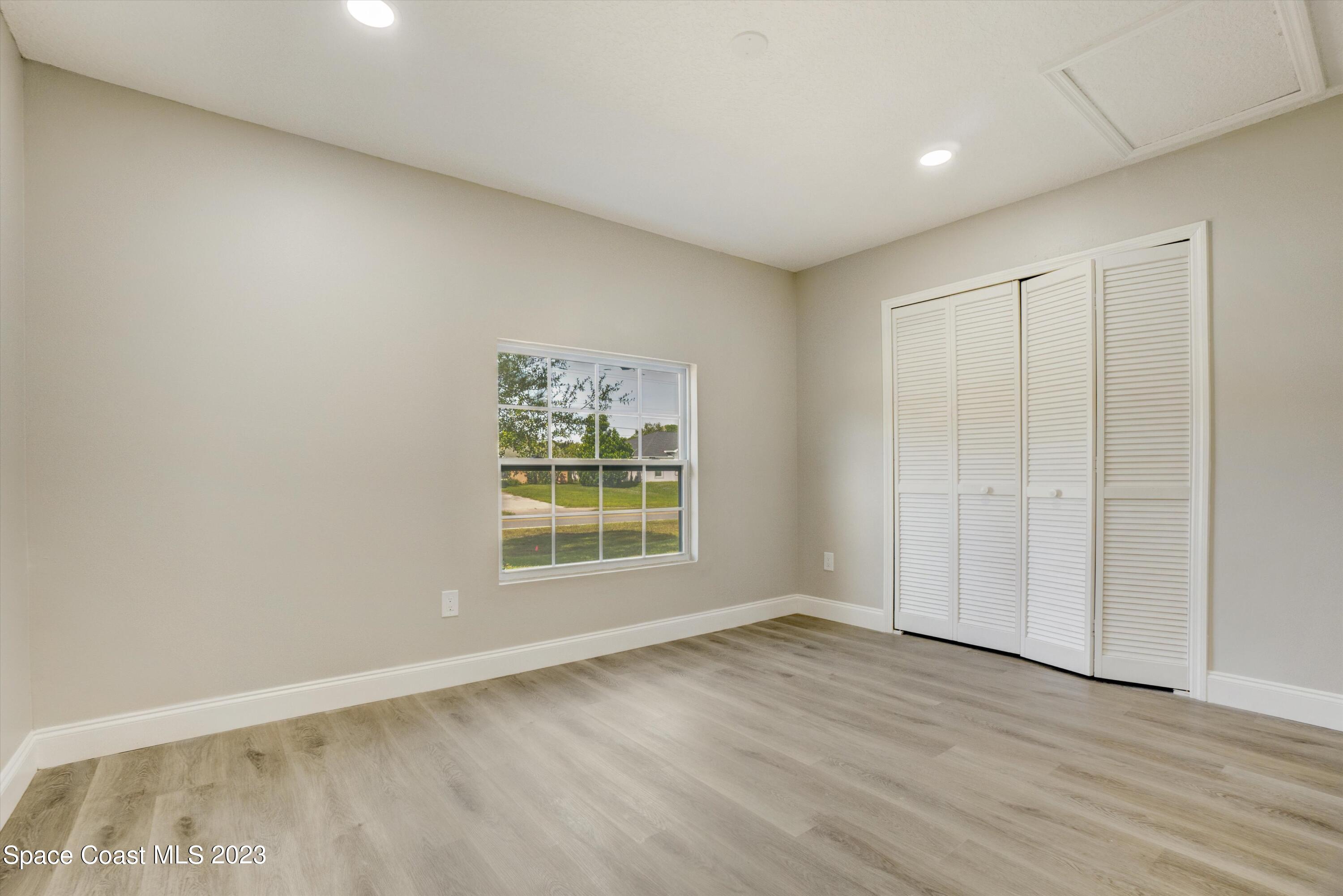 207 Eldron Boulevard Southeast Palm Bay, FL 32909 - Photo 42 of 60 an empty room with wooden floor and window