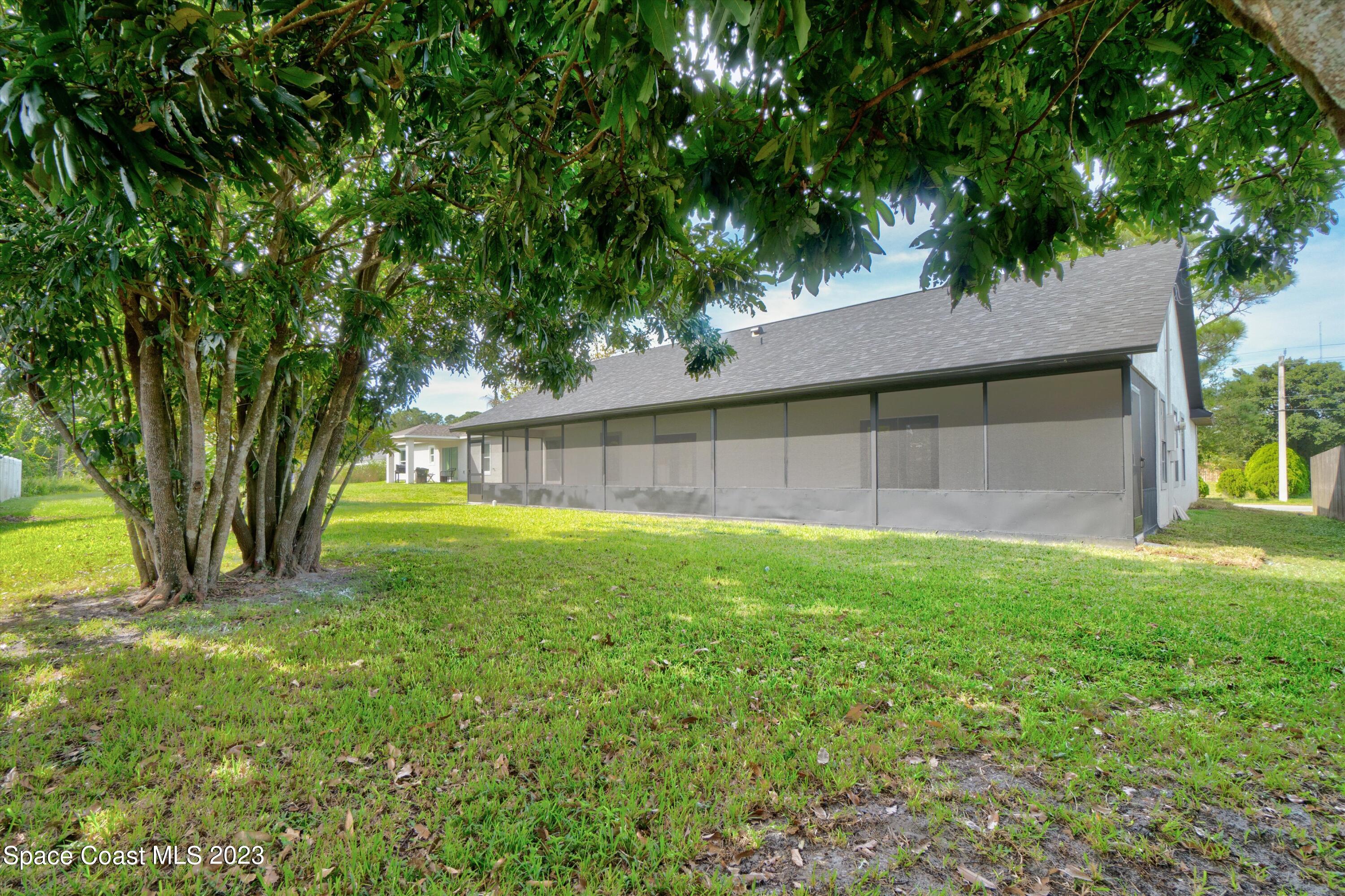 207 Eldron Boulevard Southeast Palm Bay, FL 32909 - Photo 48 of 60 a view of a backyard with a tree