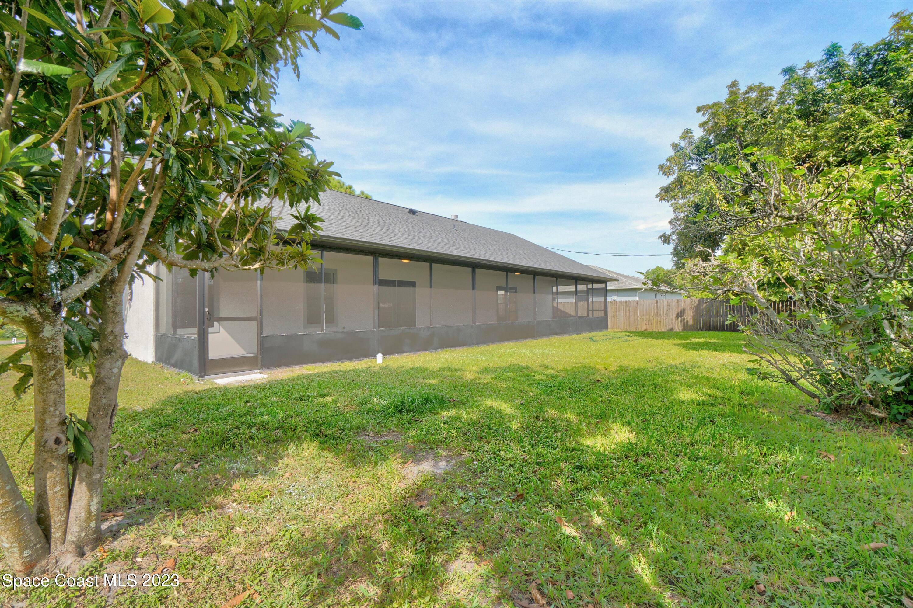 207 Eldron Boulevard Southeast Palm Bay, FL 32909 - Photo 49 of 60 a view of a backyard with a small cabin