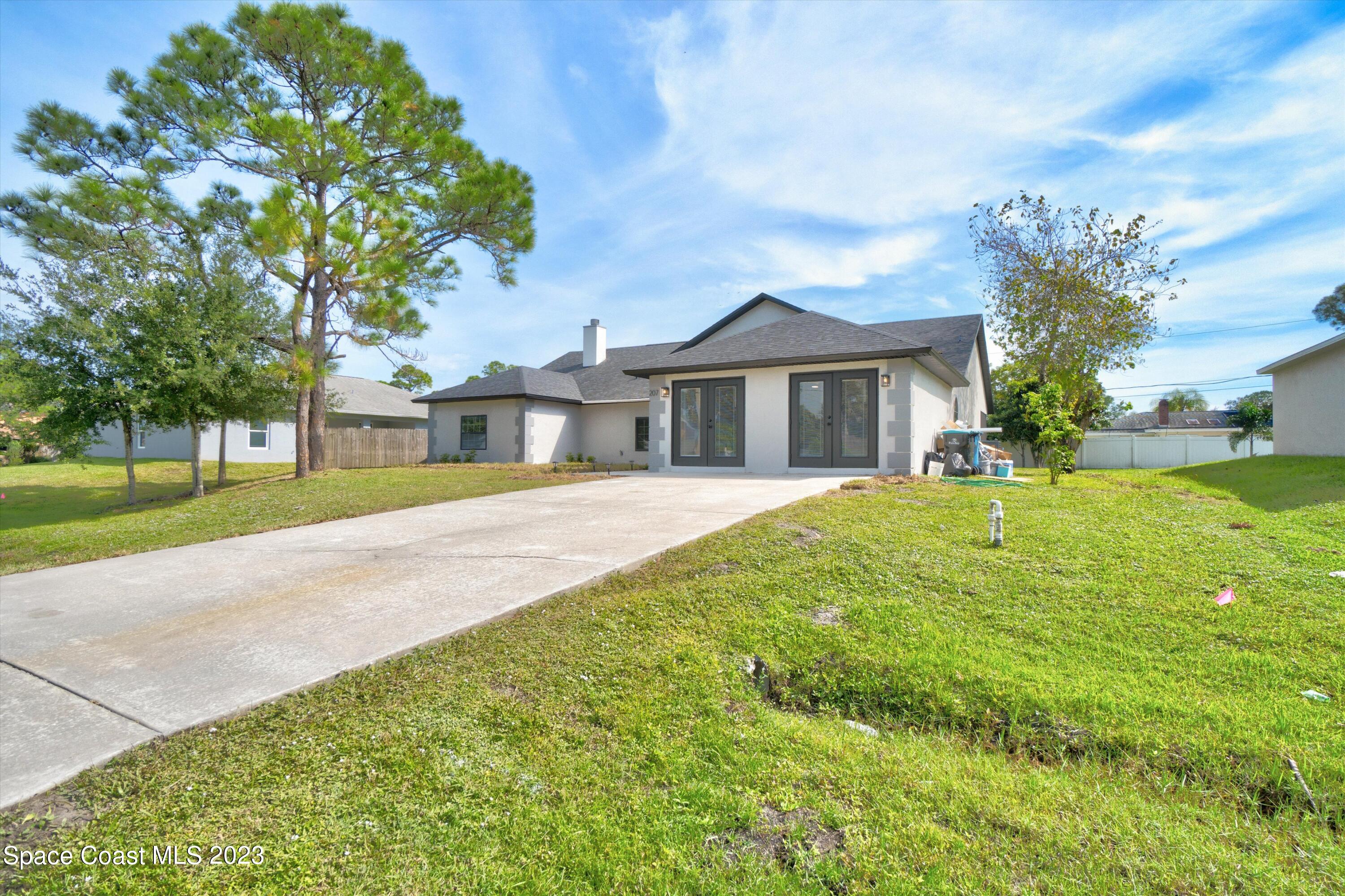 207 Eldron Boulevard Southeast Palm Bay, FL 32909 - Photo 5 of 60 a front view of a house with a yard