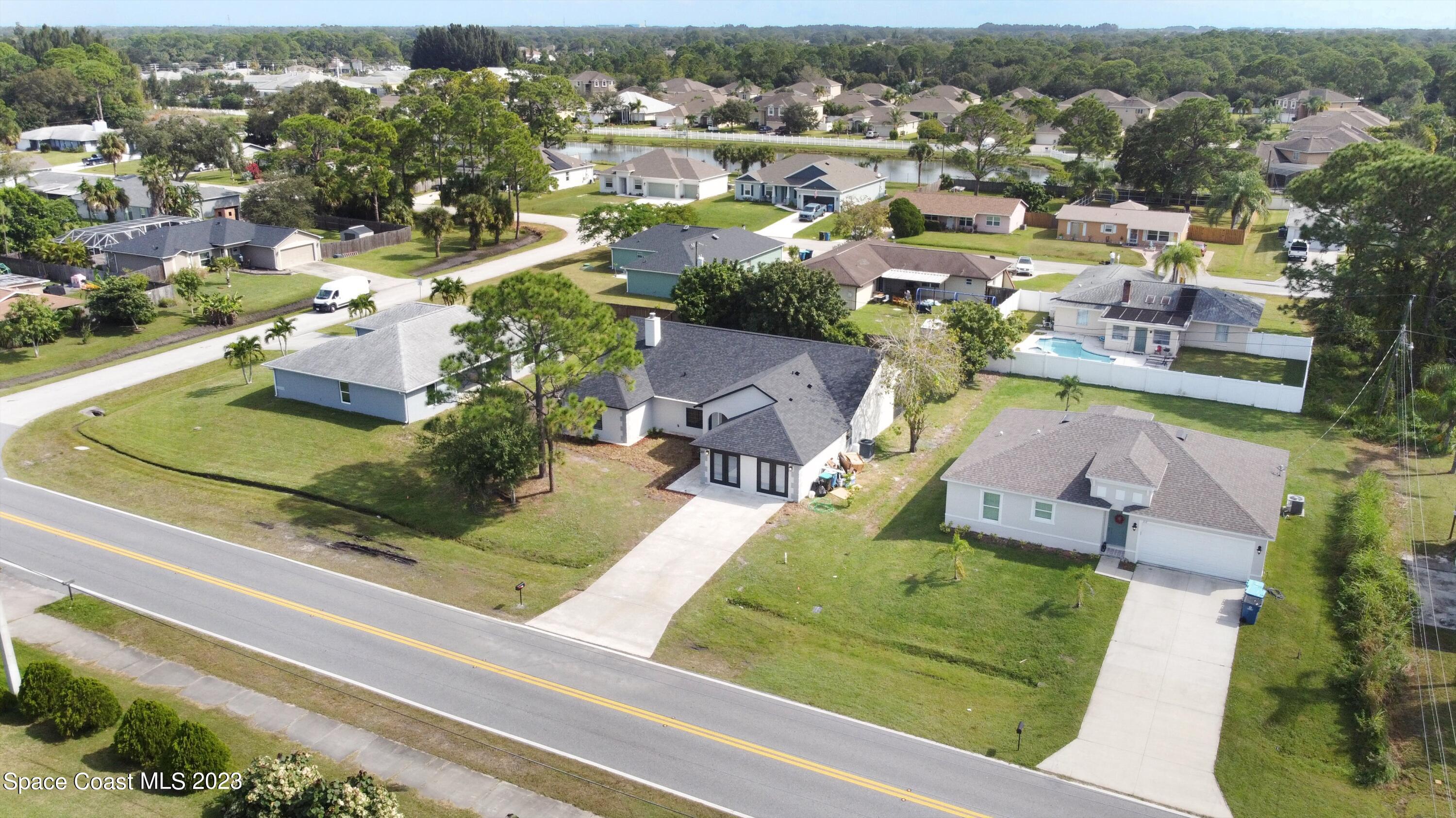 207 Eldron Boulevard Southeast Palm Bay, FL 32909 - Photo 51 of 60 an aerial view of a house with a garden