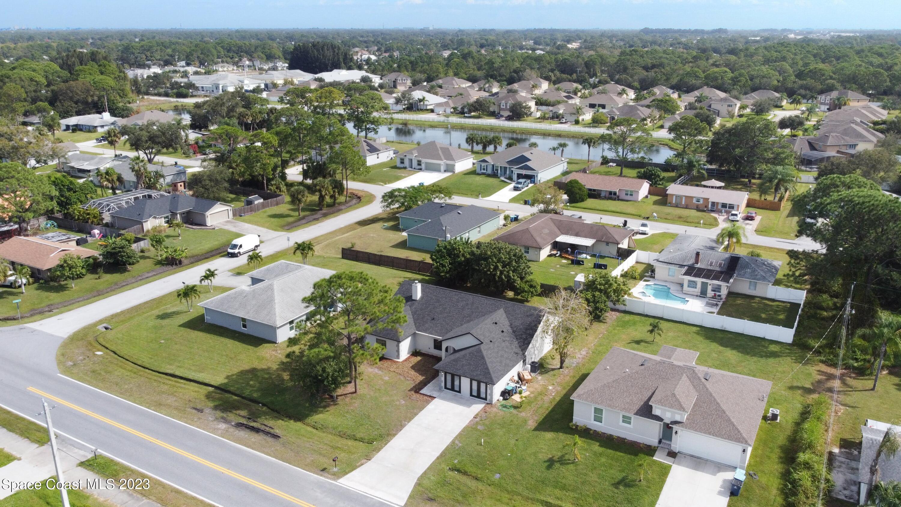 207 Eldron Boulevard Southeast Palm Bay, FL 32909 - Photo 53 of 60 an aerial view of residential houses with outdoor space and river
