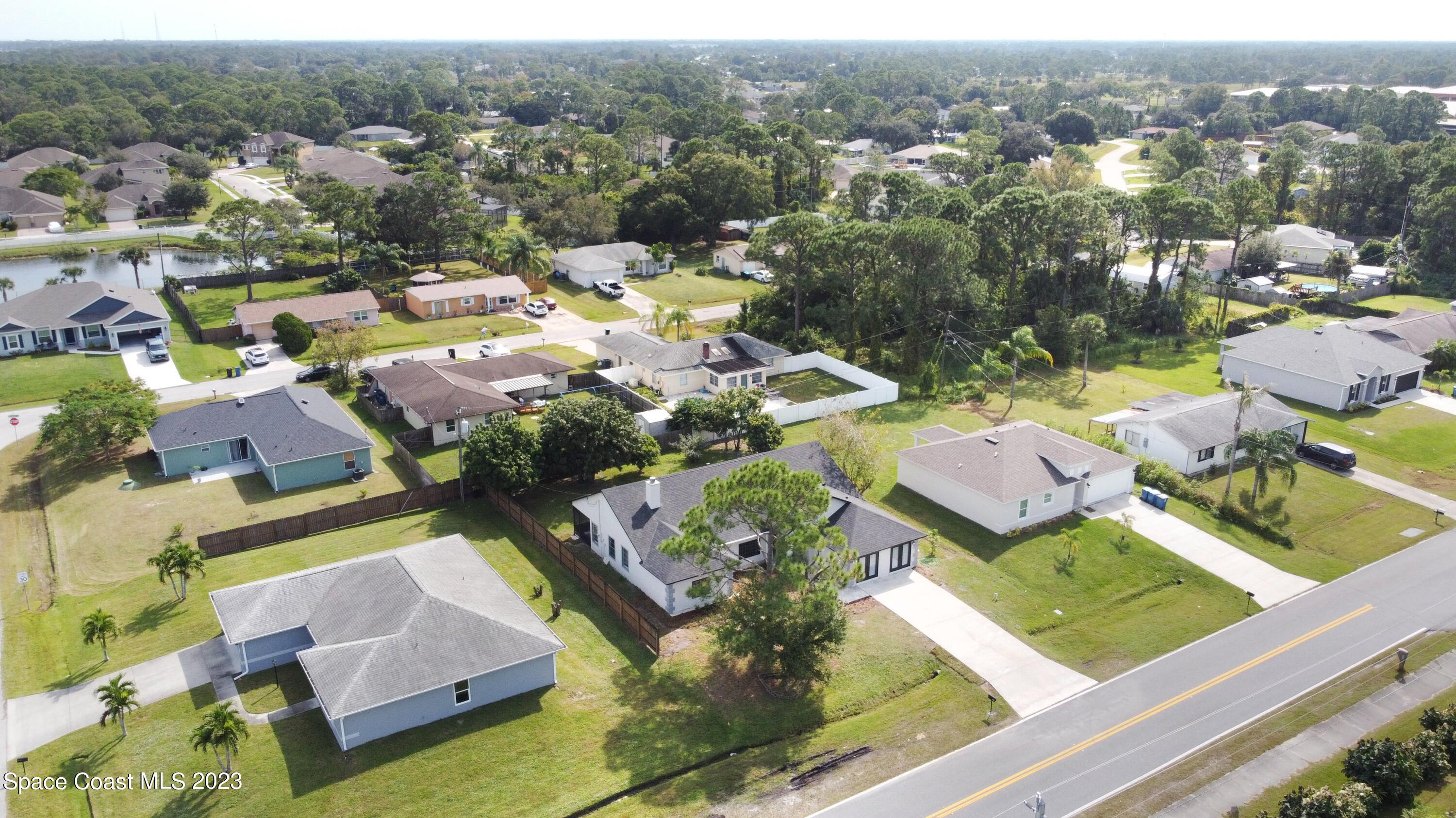 207 Eldron Boulevard Southeast Palm Bay, FL 32909 - Photo 54 of 60 an aerial view of residential houses with outdoor space