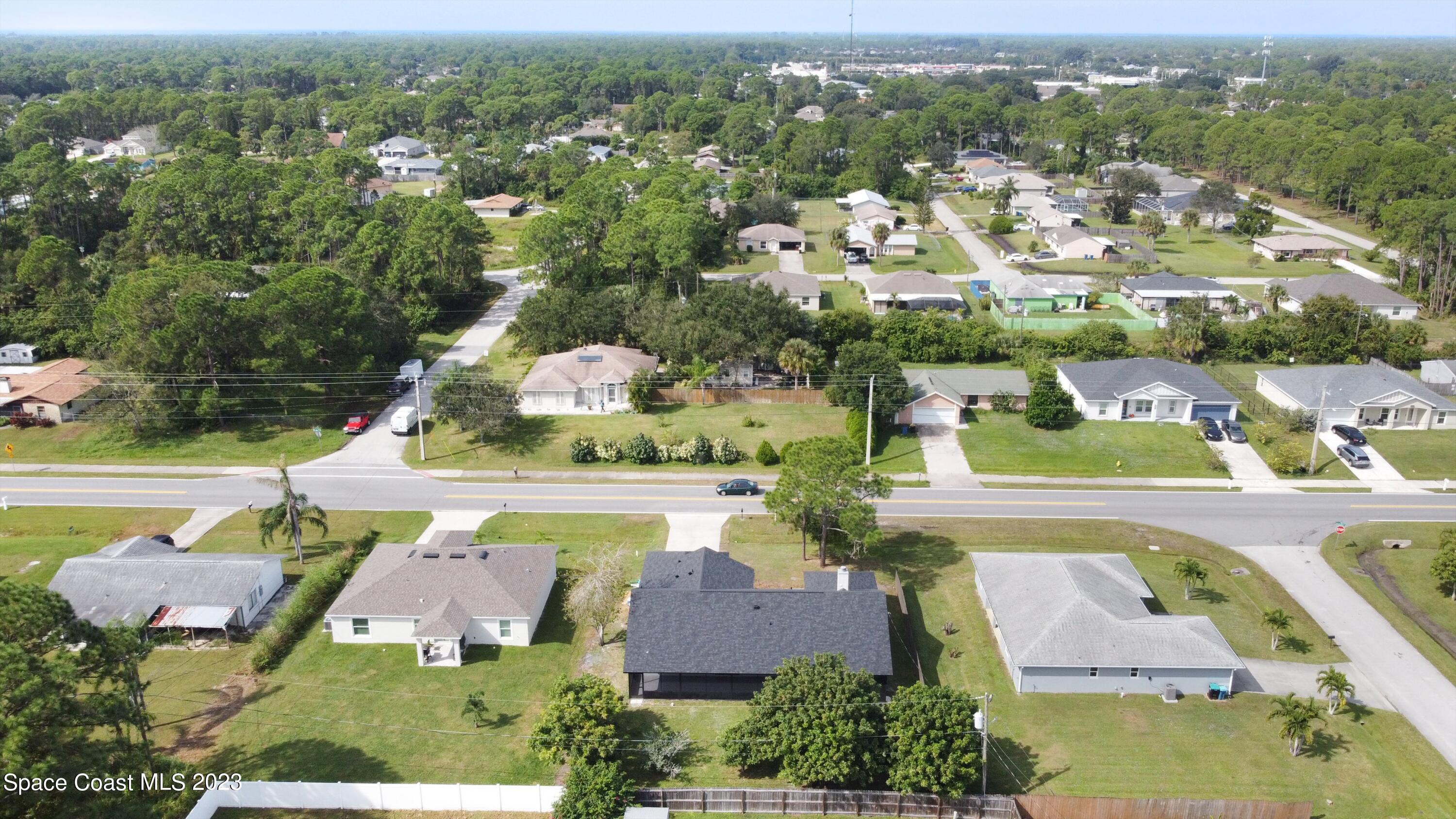 207 Eldron Boulevard Southeast Palm Bay, FL 32909 - Photo 60 of 60 an aerial view of residential houses with outdoor space and swimming pool