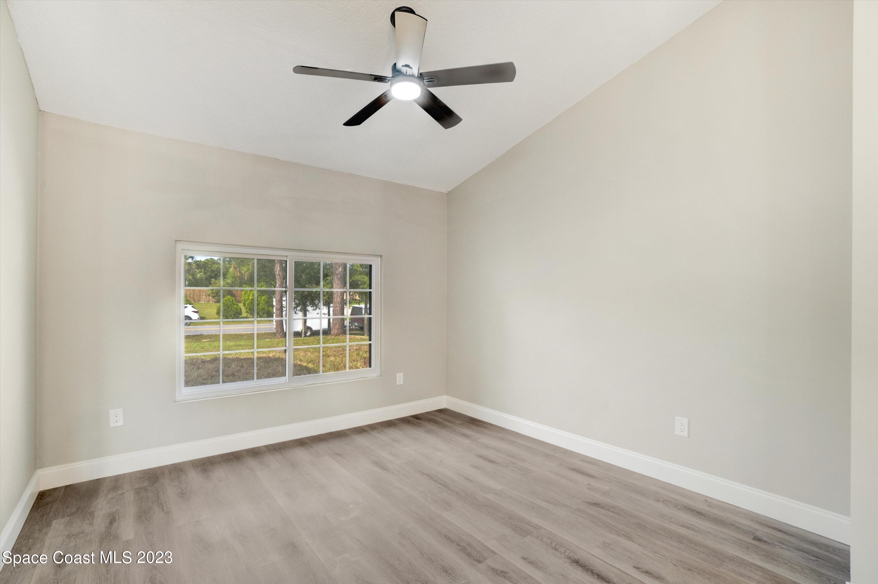 207 Eldron Boulevard Southeast Palm Bay, FL 32909 - Photo 8 of 60 an empty room with a window