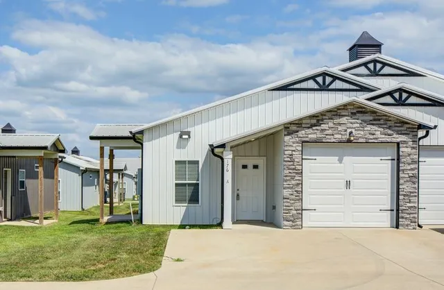 a view of a house with a yard and garage