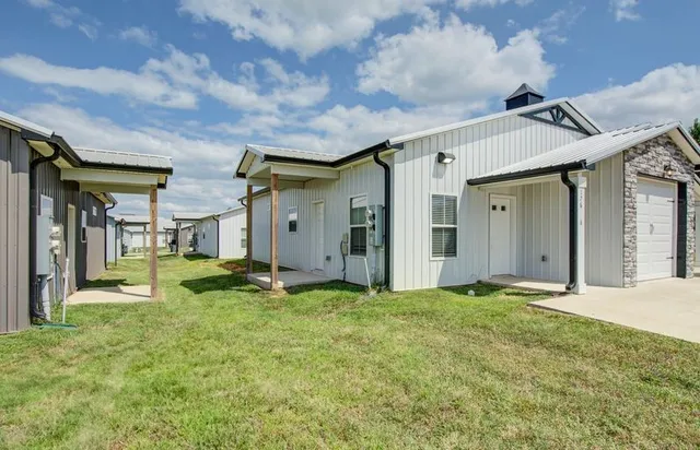 a backyard of a house with yard and garage