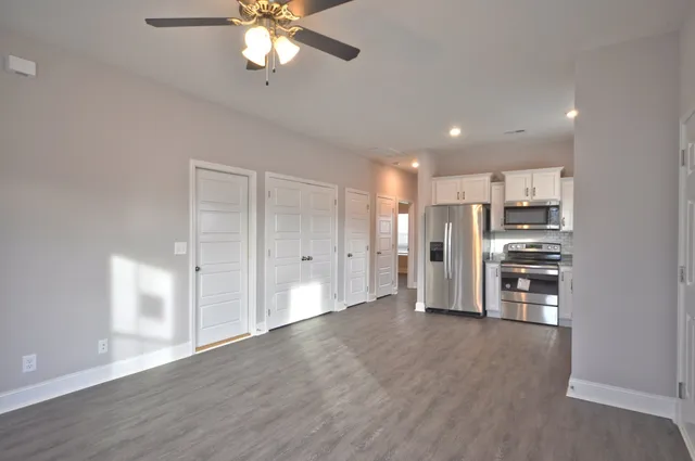 a kitchen with stainless steel appliances granite countertop a refrigerator and a sink