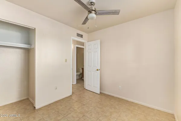 an empty room with a ceiling fan