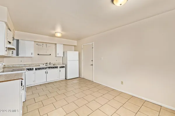 a kitchen with granite countertop white cabinets and white appliances