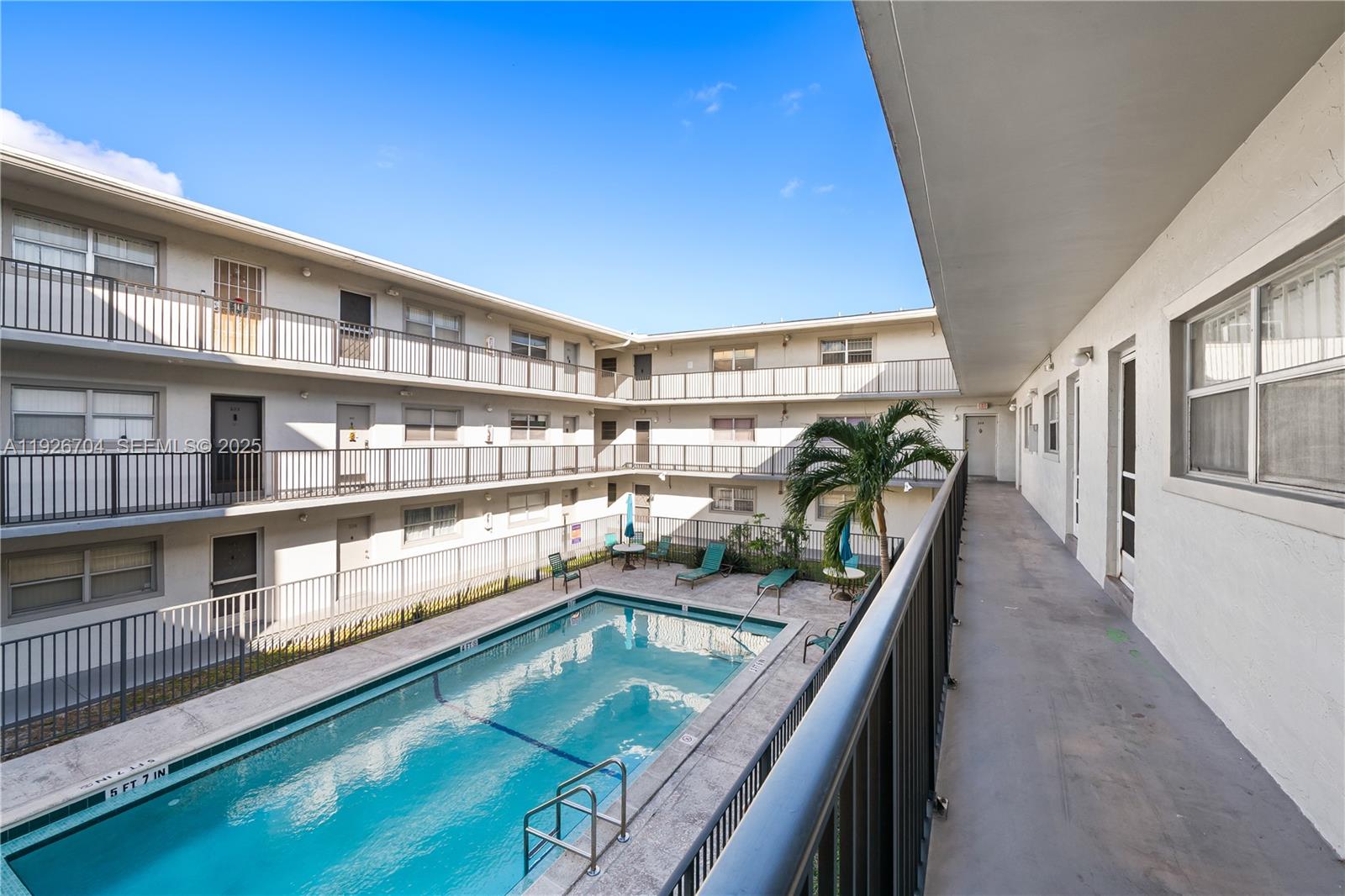 16215 Northeast 18th Court, Unit 212 North Miami Beach, FL 33162 - Photo 14 of 16 a view of a swimming pool with a balcony