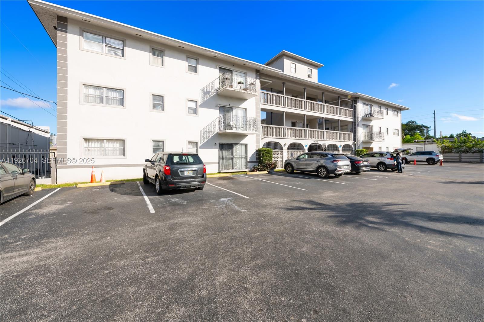 16215 Northeast 18th Court, Unit 212 North Miami Beach, FL 33162 - Photo 16 of 16 a view of a cars parked in front of a building