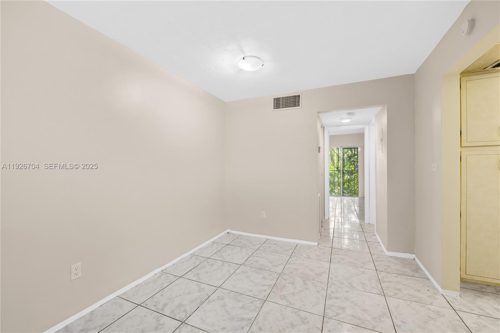 16215 Northeast 18th Court, Unit 212 North Miami Beach, FL 33162 - Photo 6 of 16 a view of an empty room and window