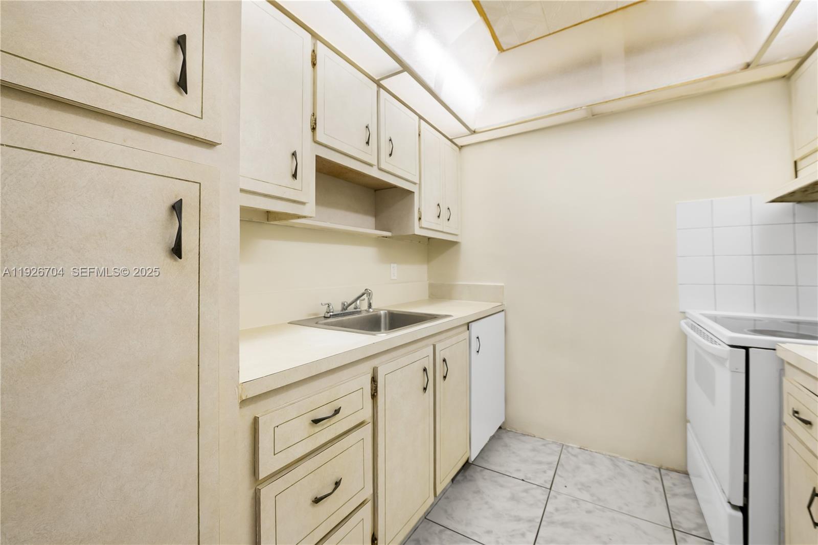 16215 Northeast 18th Court, Unit 212 North Miami Beach, FL 33162 - Photo 7 of 16 a bathroom with a sink and a mirror