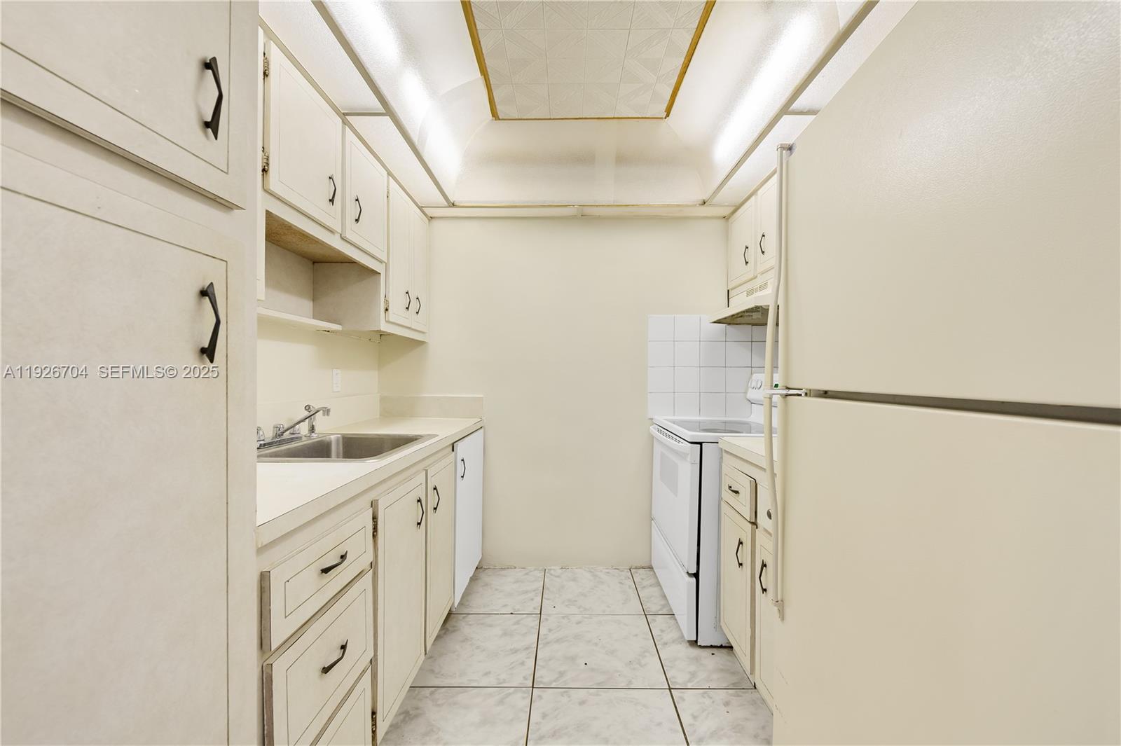 16215 Northeast 18th Court, Unit 212 North Miami Beach, FL 33162 - Photo 8 of 16 a bathroom with a sink a mirror and a shower