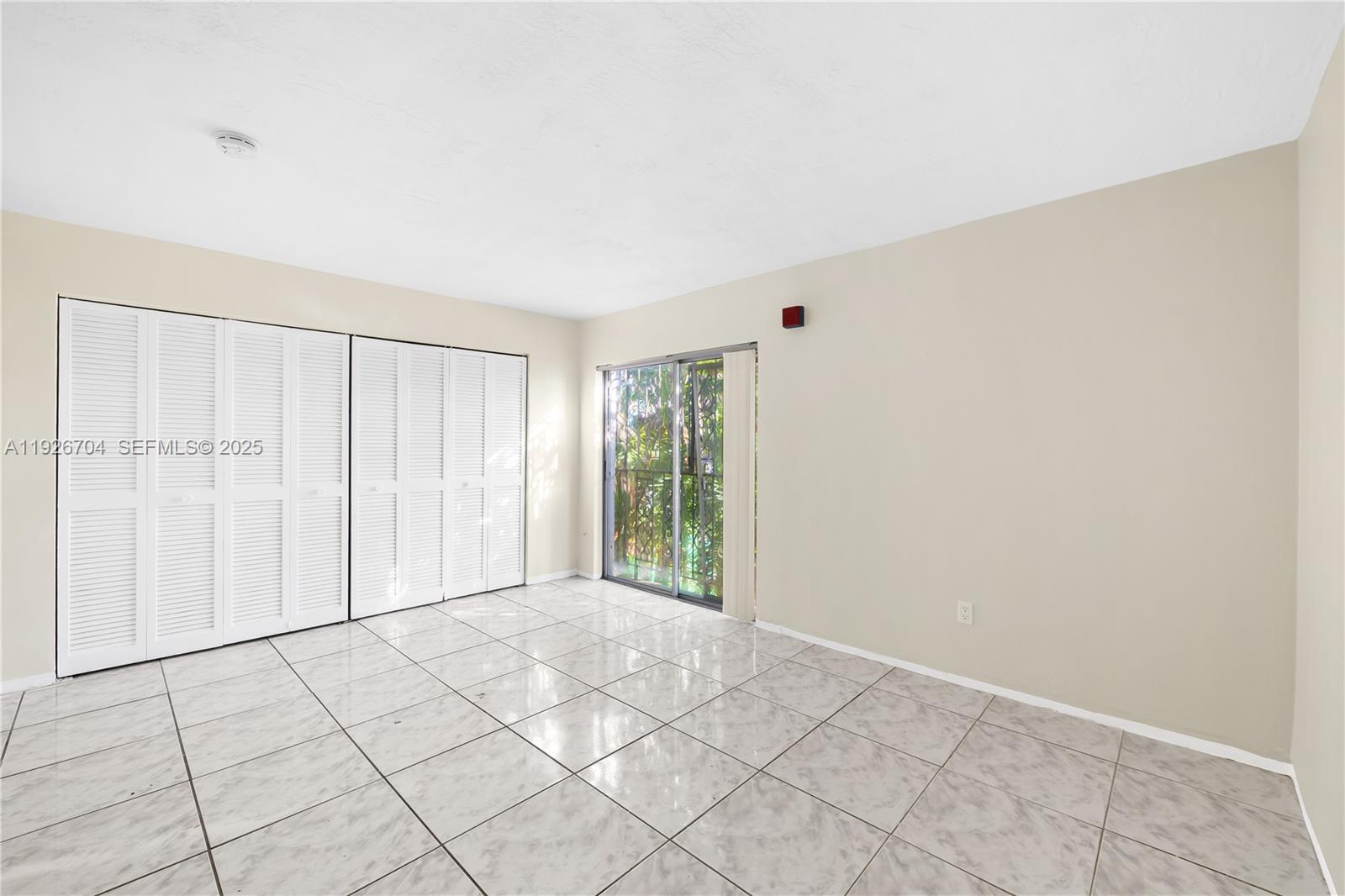 16215 Northeast 18th Court, Unit 212 North Miami Beach, FL 33162 - Photo 10 of 16 a view of an empty room with window