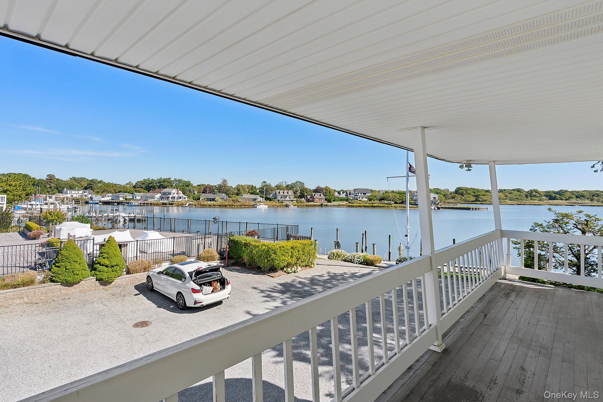 30 Little Neck Road, Unit 21 Southampton, NY 11968 - Photo 1 of 1 a view of swimming pool with a table and chairs under an umbrella
