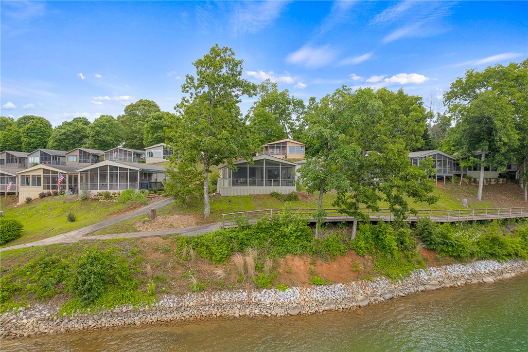 1230 Melton Road, Unit 30 West Union, SC 29696 - Photo 34 of 42 Discover a tranquil lakeside retreat with multiple homes offering screened porches and direct water access.