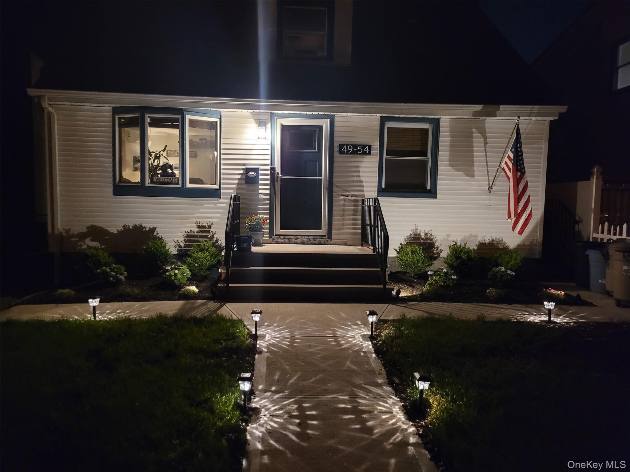 49-54 166th Street Queens, NY 11365 - Photo 2 of 41 a front view of a house with garden