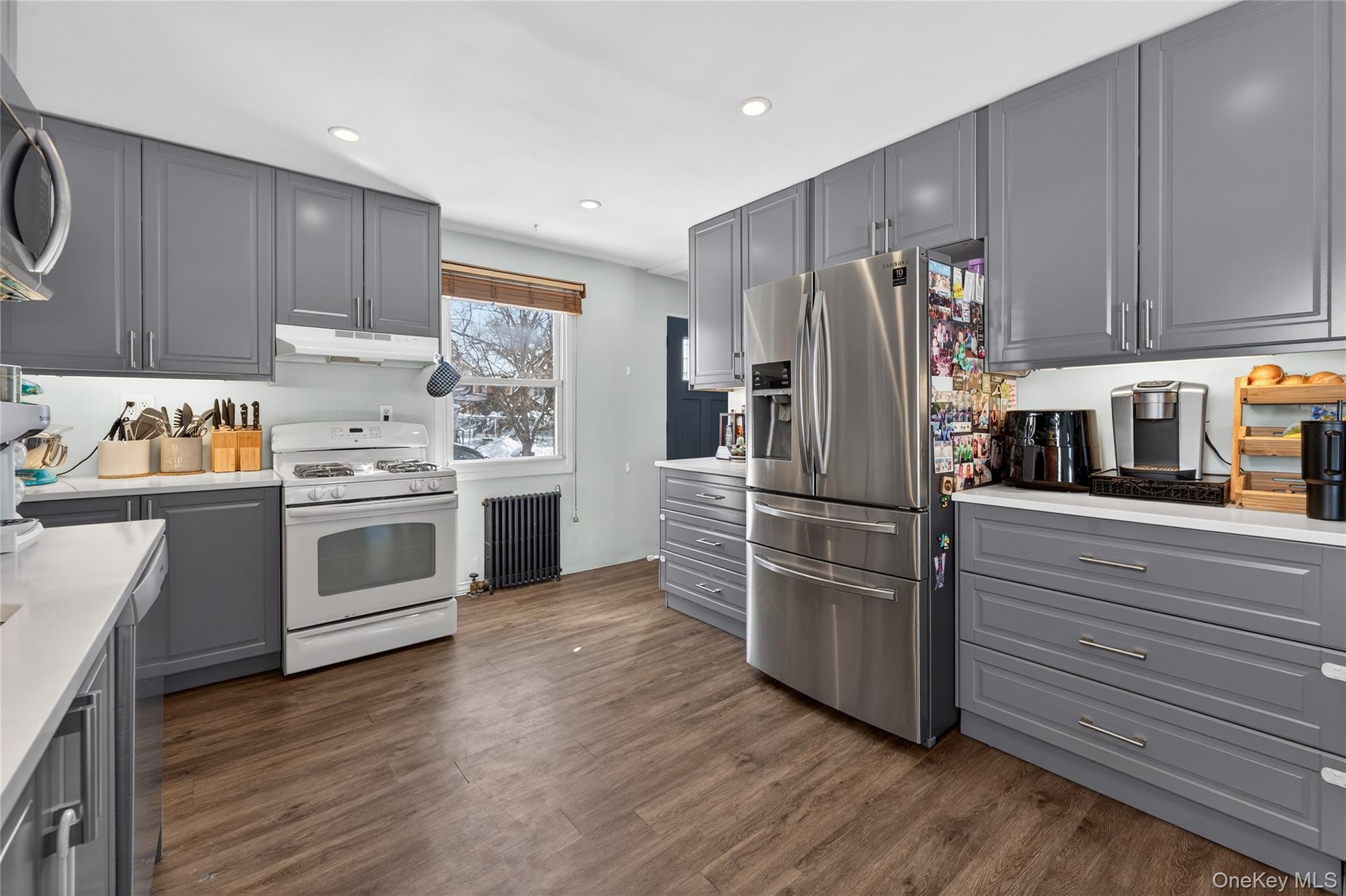 49-54 166th Street Queens, NY 11365 - Photo 22 of 41 a kitchen with a refrigerator stove and wooden cabinets