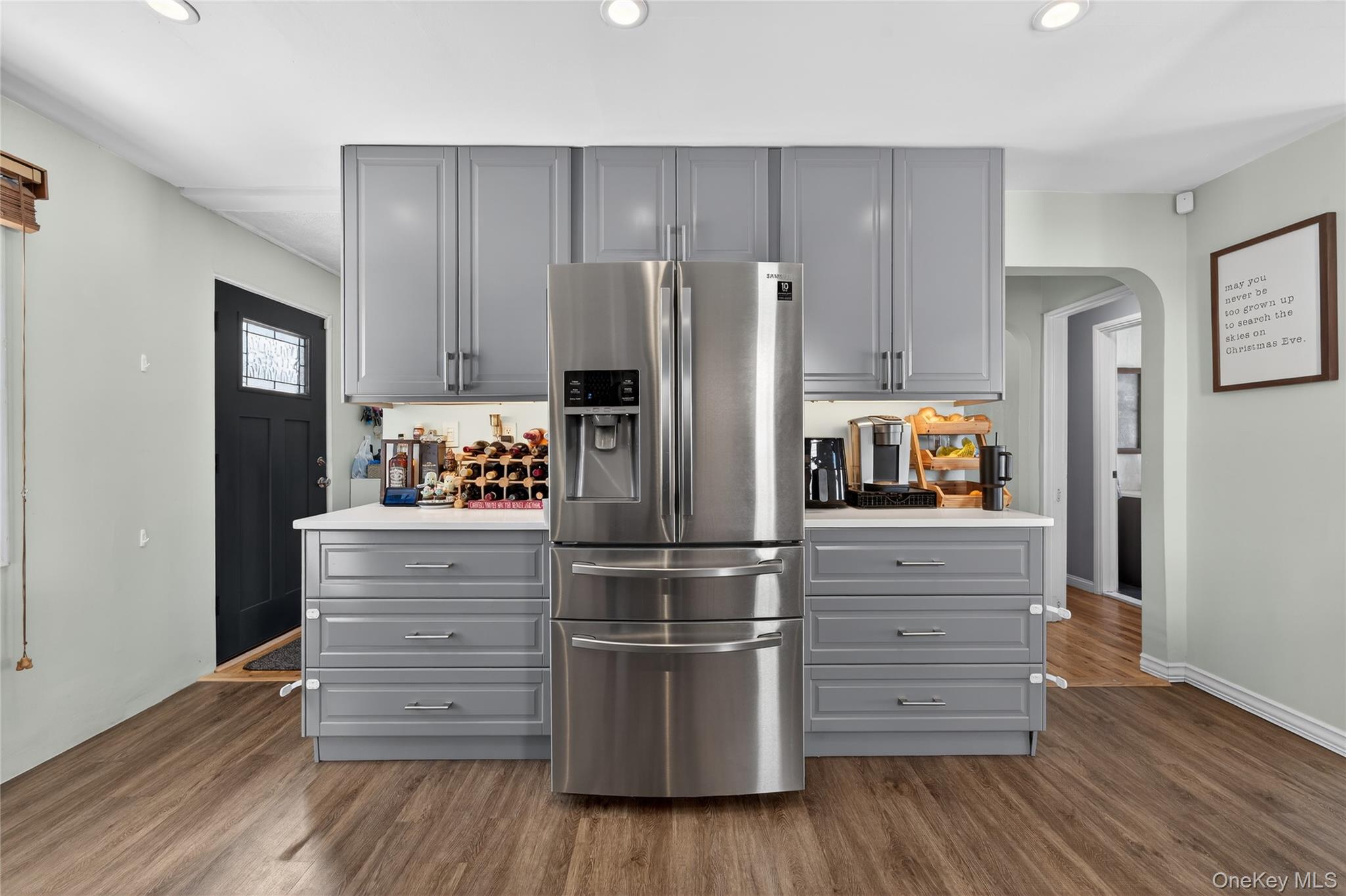 49-54 166th Street Queens, NY 11365 - Photo 23 of 41 a kitchen with cabinets and wooden floor