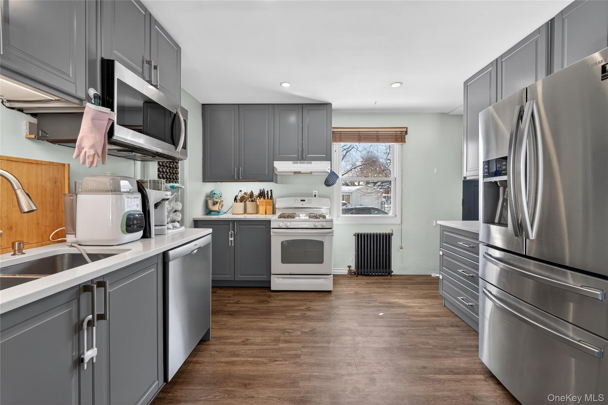 49-54 166th Street Queens, NY 11365 - Photo 27 of 41 a kitchen with stainless steel appliances a refrigerator stove and sink