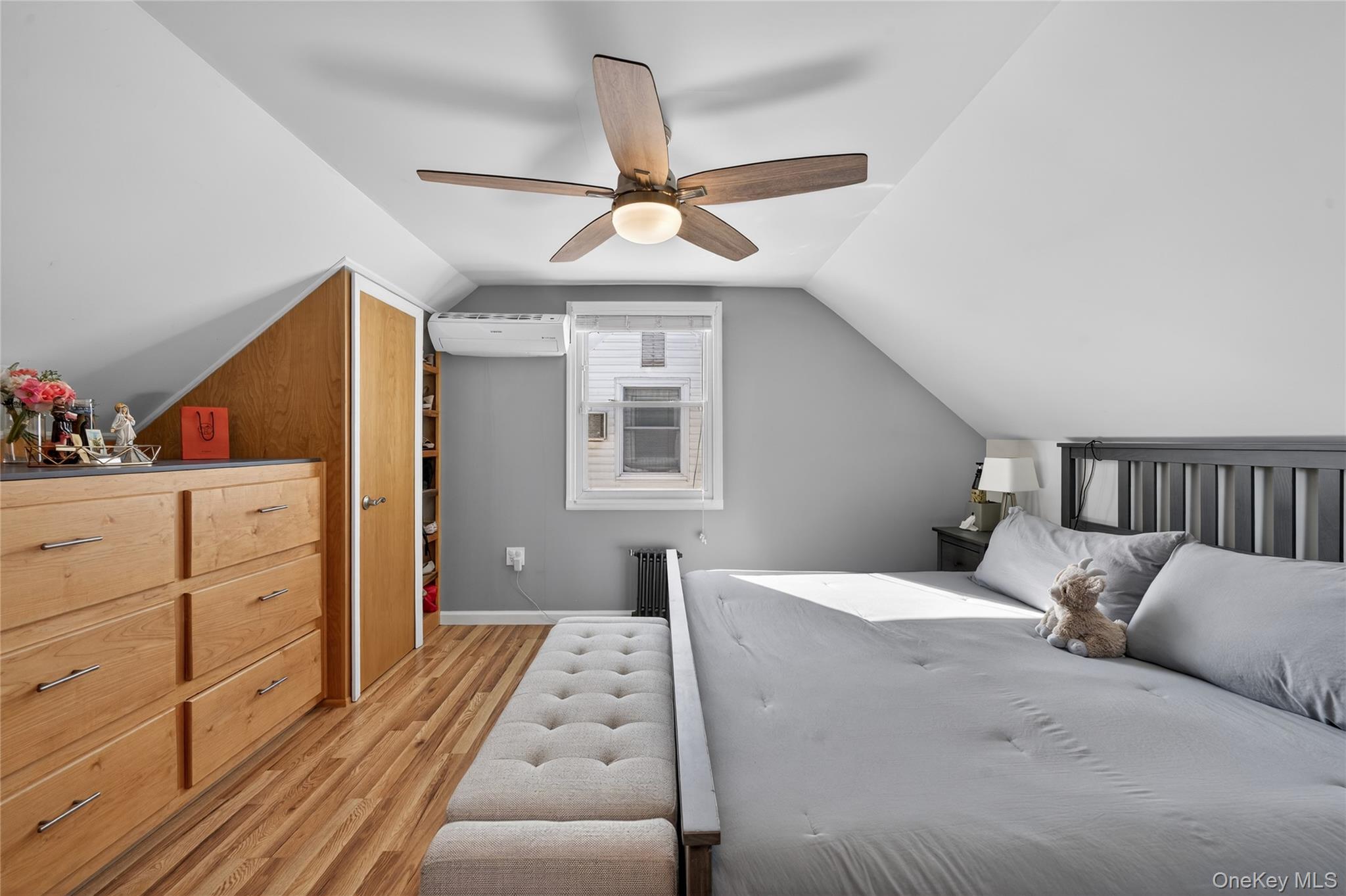 49-54 166th Street Queens, NY 11365 - Photo 28 of 41 a bedroom with a bed and wooden floor