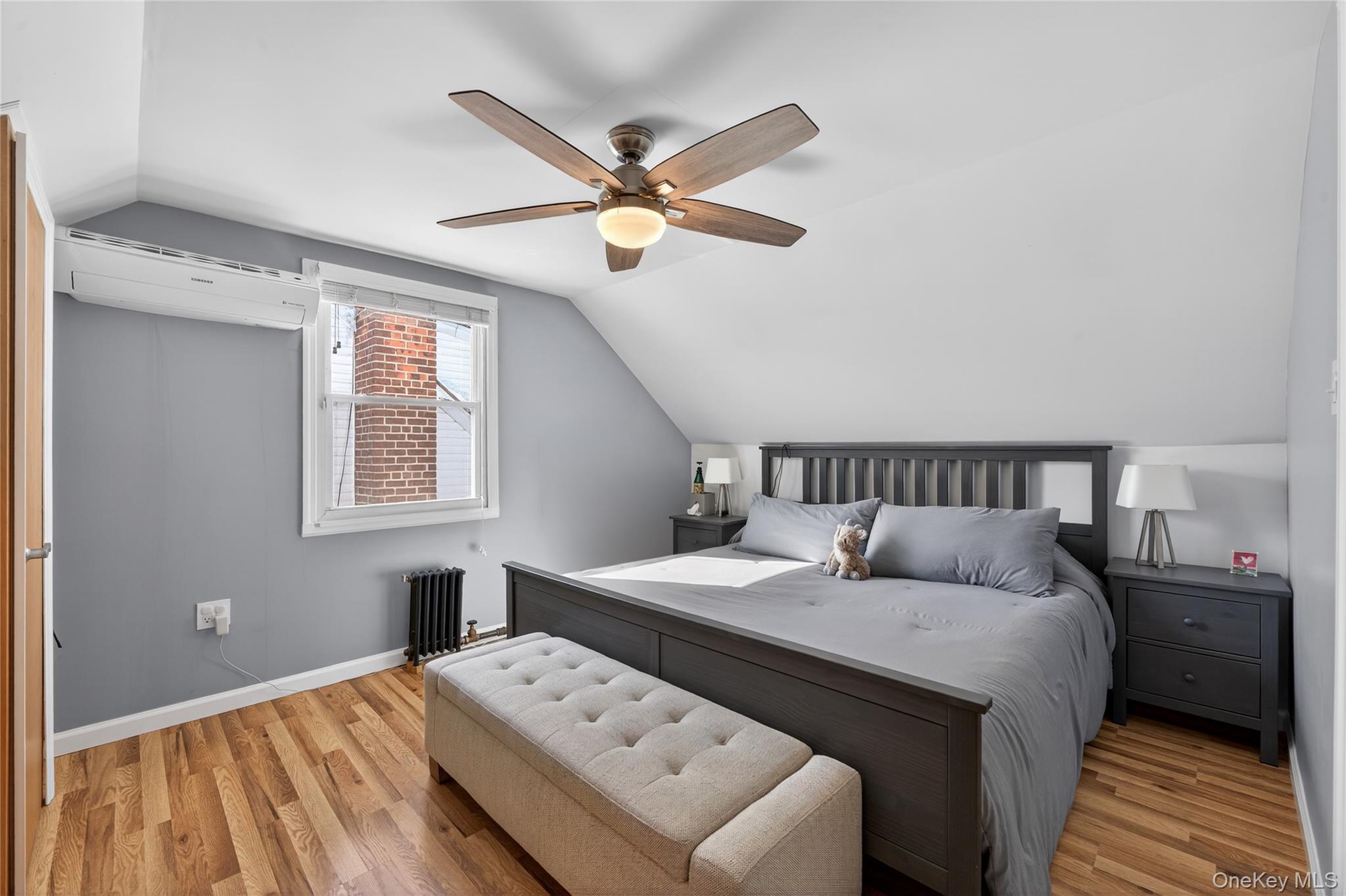 49-54 166th Street Queens, NY 11365 - Photo 29 of 41 a bedroom with a bed and a chandelier