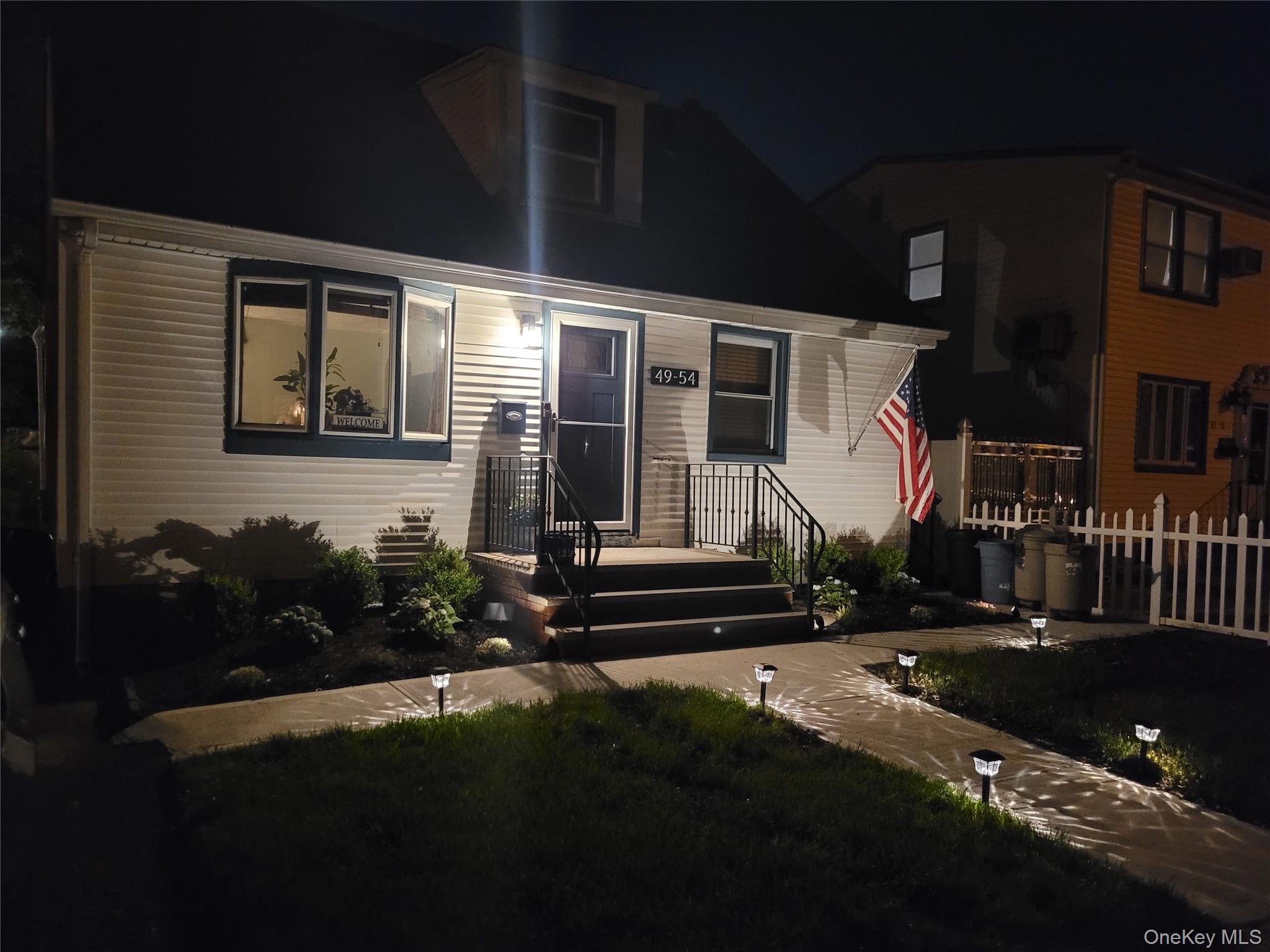 49-54 166th Street Queens, NY 11365 - Photo 3 of 41 a front view of a house with a yard