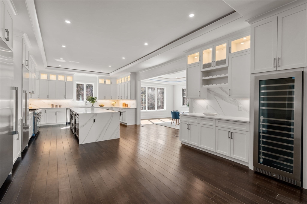 51 Plympton Road Sudbury, MA 01776 - Photo 11 of 38 a large white kitchen with lots of counter space wooden floor and appliances
