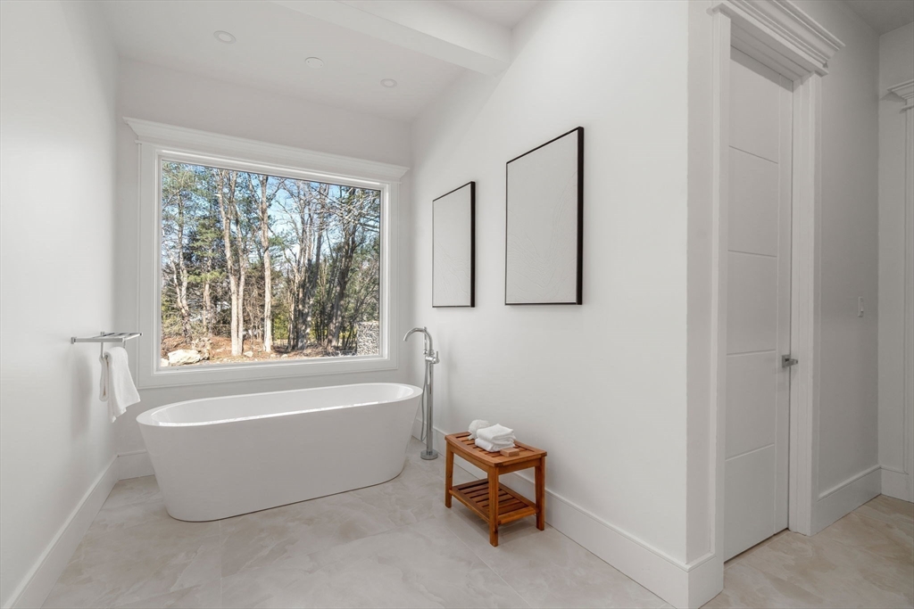 51 Plympton Road Sudbury, MA 01776 - Photo 17 of 38 a bathroom with a bathtub and window