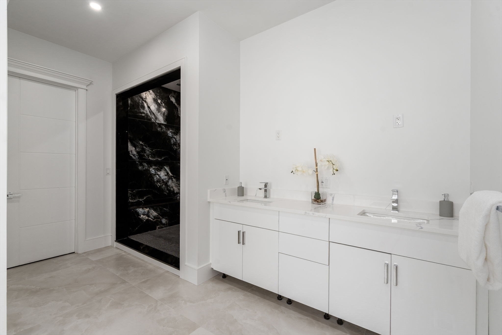 51 Plympton Road Sudbury, MA 01776 - Photo 18 of 38 a bathroom with a double vanity sink and mirror
