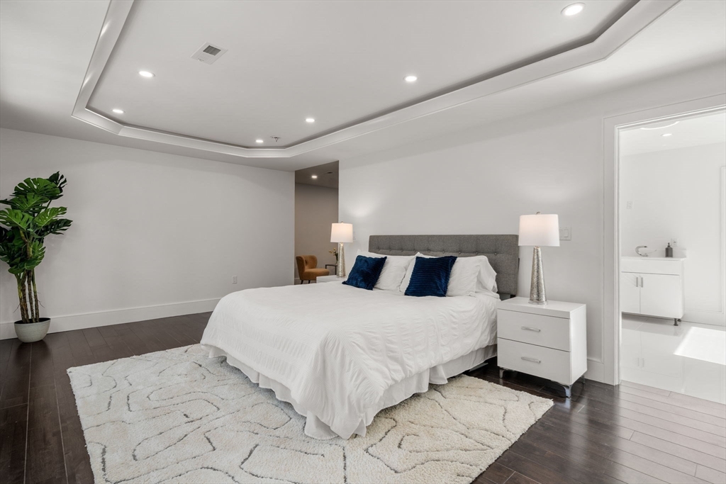 51 Plympton Road Sudbury, MA 01776 - Photo 20 of 38 a bedroom with a large bed and a potted plant