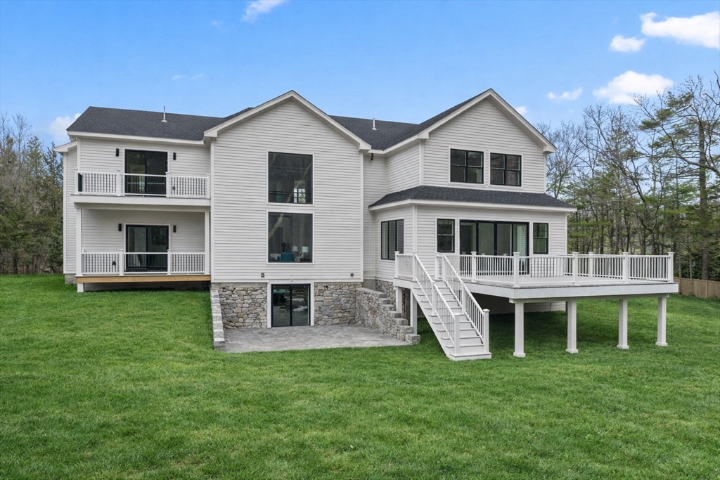 51 Plympton Road Sudbury, MA 01776 - Photo 2 of 38 a front view of a house with a garden and porch