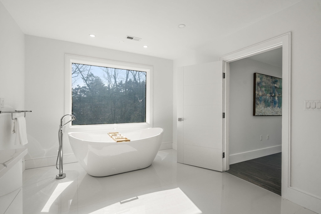 51 Plympton Road Sudbury, MA 01776 - Photo 23 of 38 a white bath tub sitting in a room