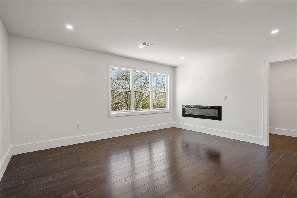 51 Plympton Road Sudbury, MA 01776 - Photo 25 of 38 an empty room with wooden floor and windows