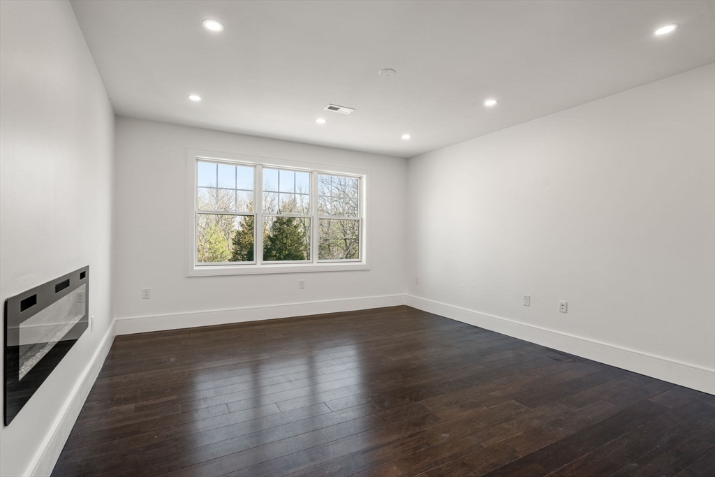 51 Plympton Road Sudbury, MA 01776 - Photo 26 of 38 an empty room with wooden floor and windows