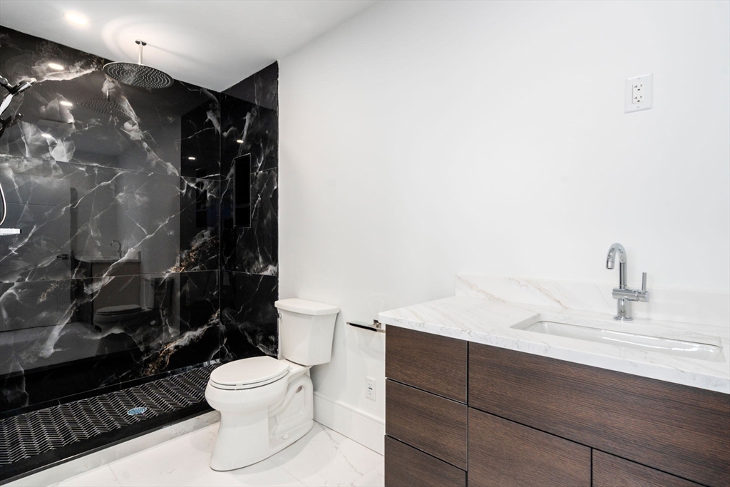 51 Plympton Road Sudbury, MA 01776 - Photo 27 of 38 a bathroom with a toilet sink and shower