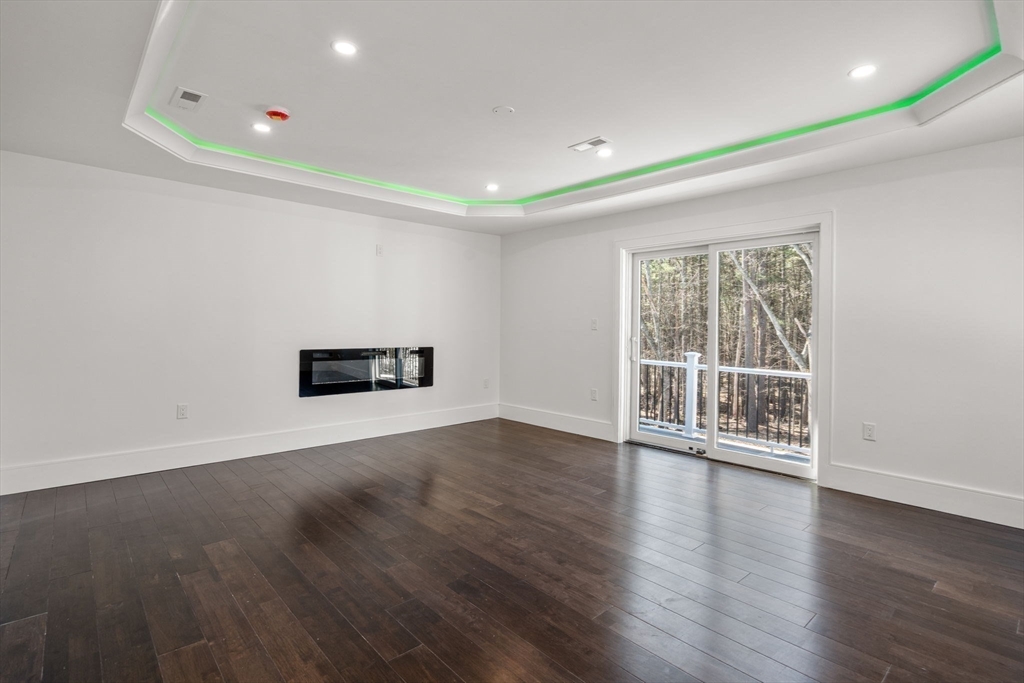 51 Plympton Road Sudbury, MA 01776 - Photo 28 of 38 an empty room with wooden floor and windows
