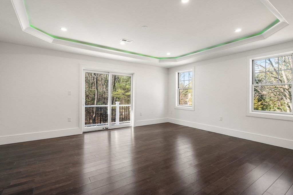 51 Plympton Road Sudbury, MA 01776 - Photo 29 of 38 a view of an empty room with wooden floor and a window