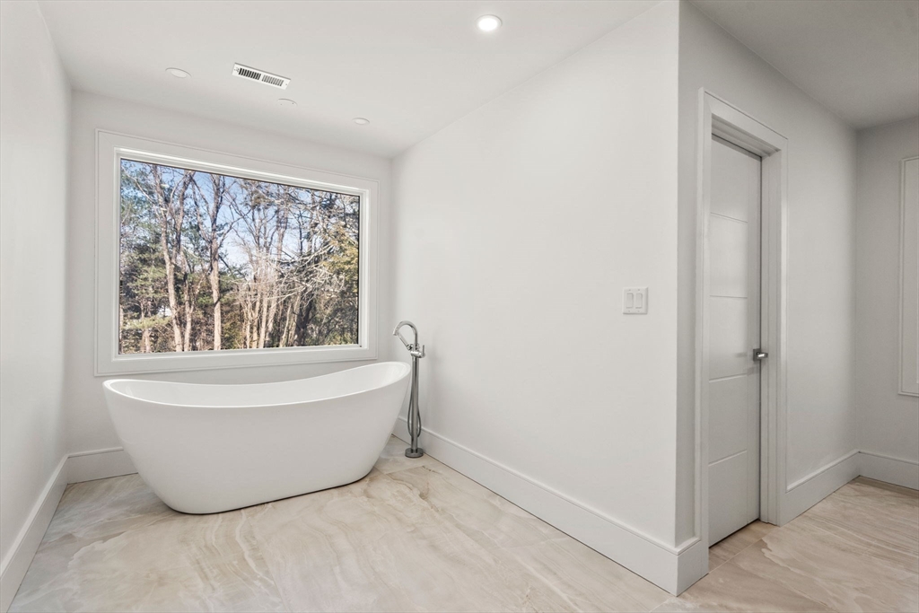 51 Plympton Road Sudbury, MA 01776 - Photo 31 of 38 a white bath tub sitting in a room