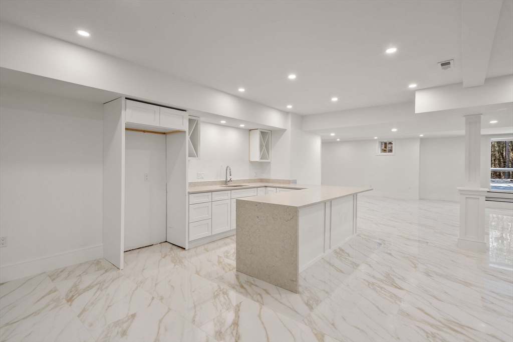 51 Plympton Road Sudbury, MA 01776 - Photo 32 of 38 a large kitchen with kitchen island a sink stainless steel appliances and cabinets