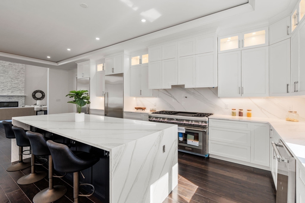 51 Plympton Road Sudbury, MA 01776 - Photo 9 of 38 a kitchen with a stove a sink and a refrigerator