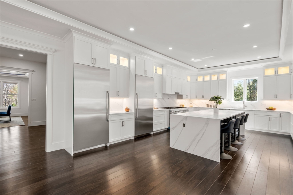 51 Plympton Road Sudbury, MA 01776 - Photo 10 of 38 a kitchen with stainless steel appliances a sink cabinets and wooden floor