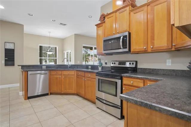a kitchen with stainless steel appliances granite countertop a sink and a stove