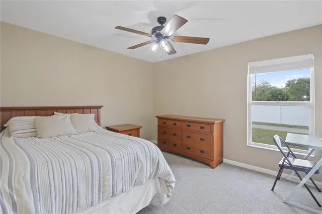 a bedroom with a bed and a dresser