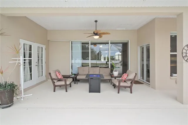a living room with furniture and large windows
