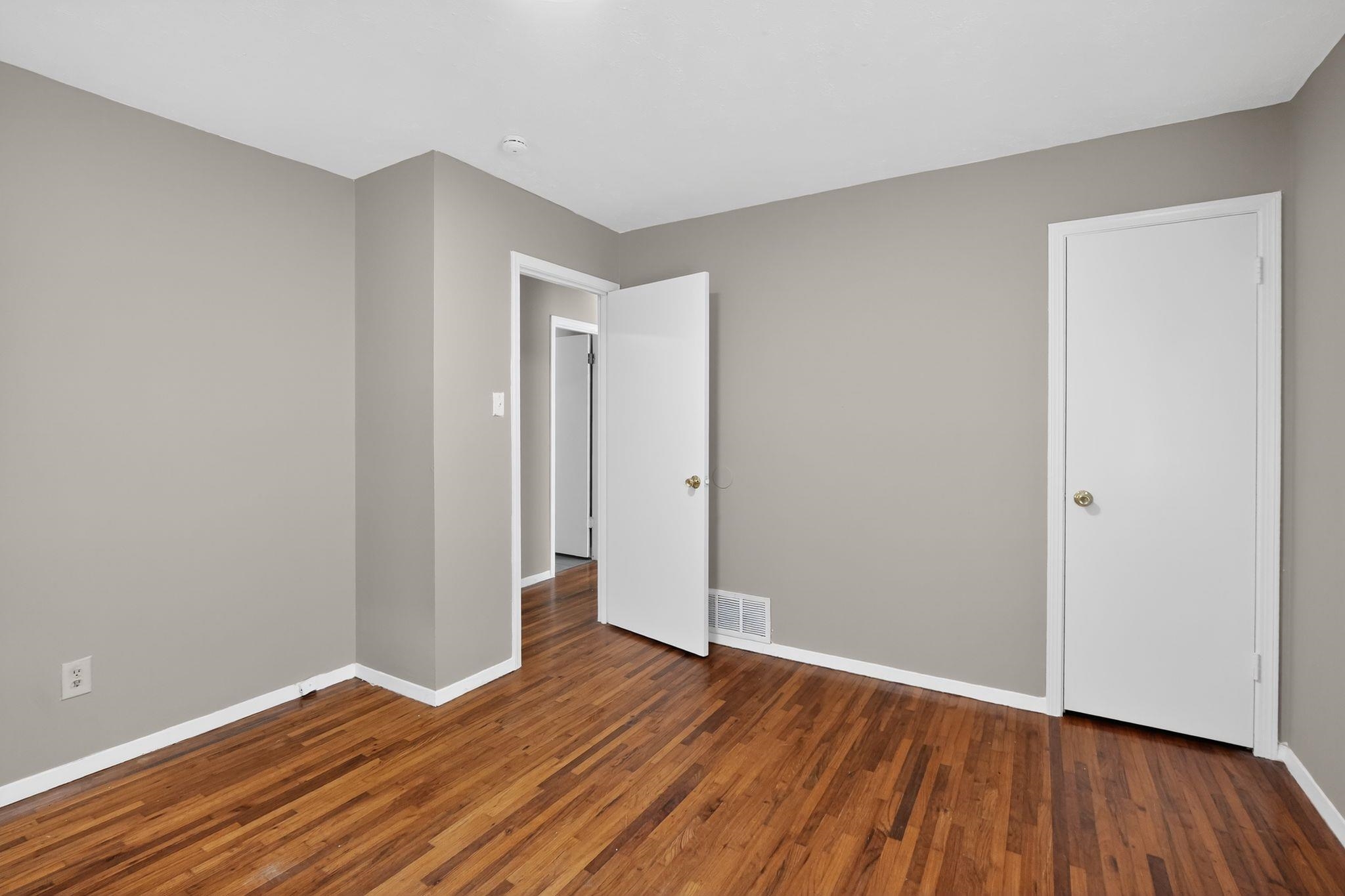 4955 Stacey Road Memphis, TN 38109 - Photo 29 of 35 Room featuring wood-finish flooring, light gray wall paint, and white trim