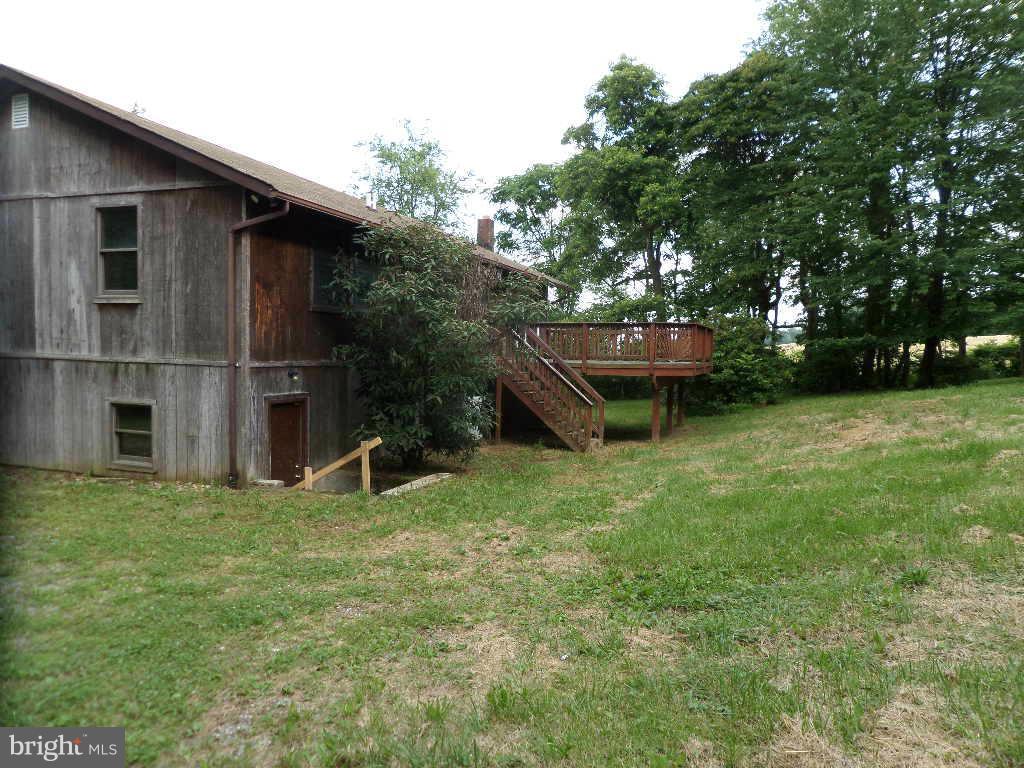 4242 Roop Road Mount Airy, MD 21771 - Photo 12 of 14 a view of a backyard with table and chairs with wooden fence and plants