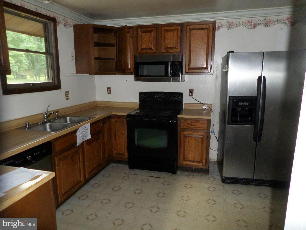 4242 Roop Road Mount Airy, MD 21771 - Photo 3 of 14 a kitchen with a sink stove and refrigerator